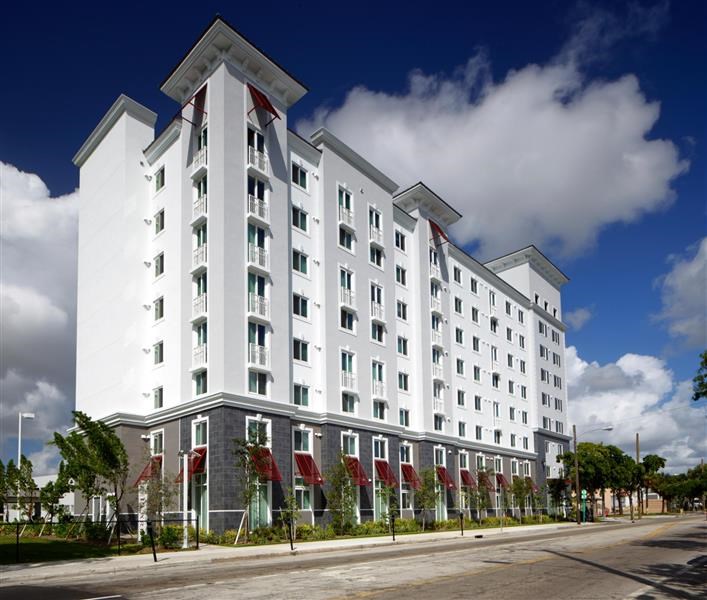 a large white building with a street in front of it