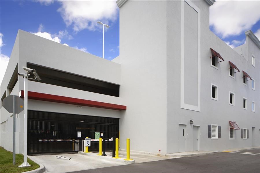 a large white building with a black garage door