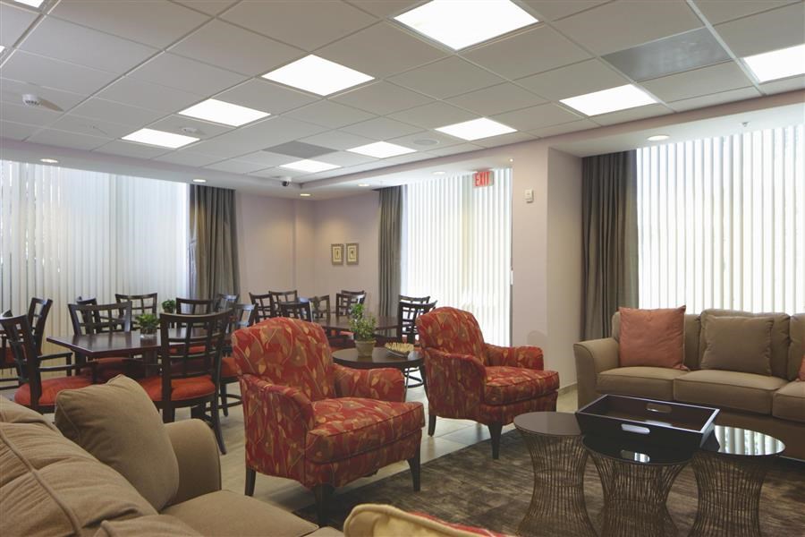 a living room with a couch and chairs and a table