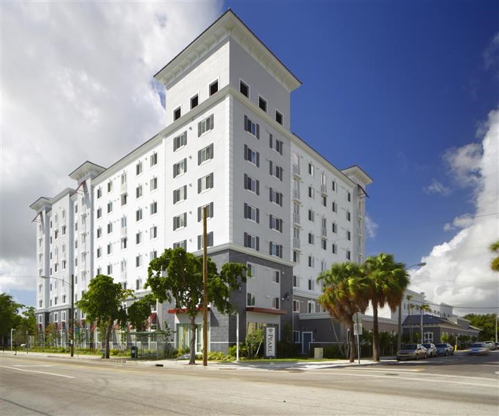 a large white building on the side of a street