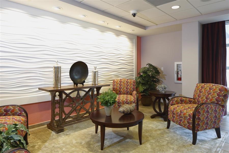 a living room with chairs and a table