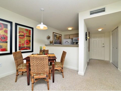 a dining room with a wooden table and chairs