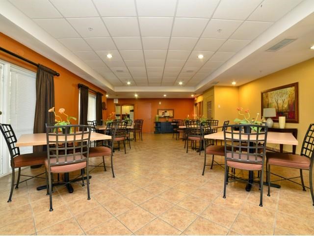 a large dining room with tables and chairs