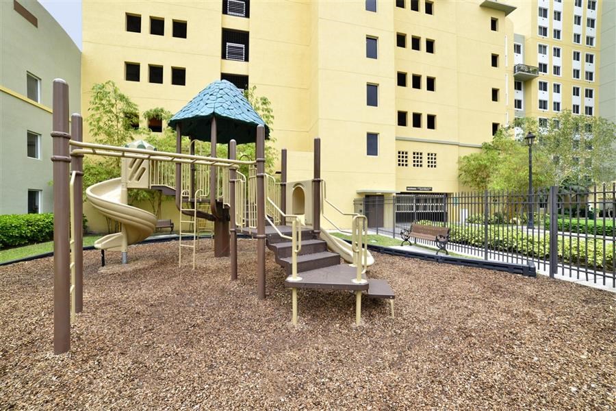a playground with a building in the background
