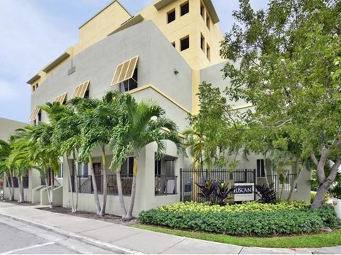 a white building with palm trees in front of it