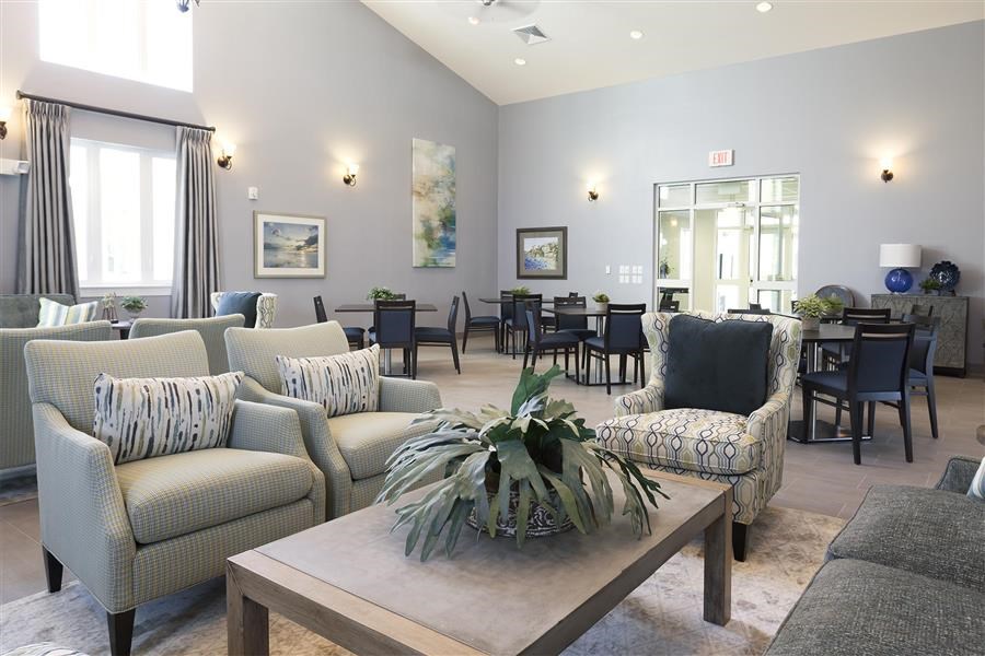 a living room with couches and chairs and a table