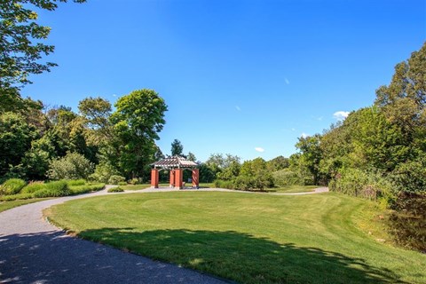 a pathway leading to a gazebo in a park