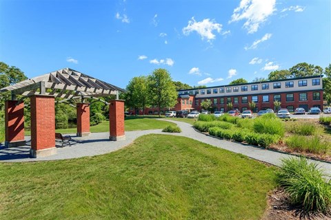 a park with a walkway and a building
