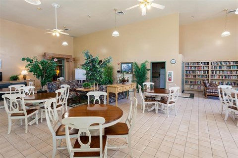 a dining room with tables and chairs in a library