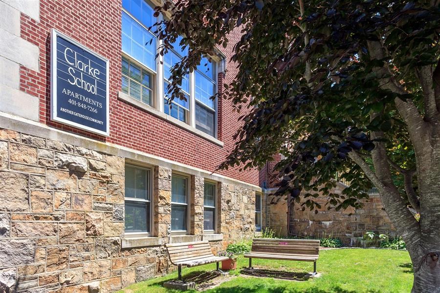 two benches in front of a building with a sign