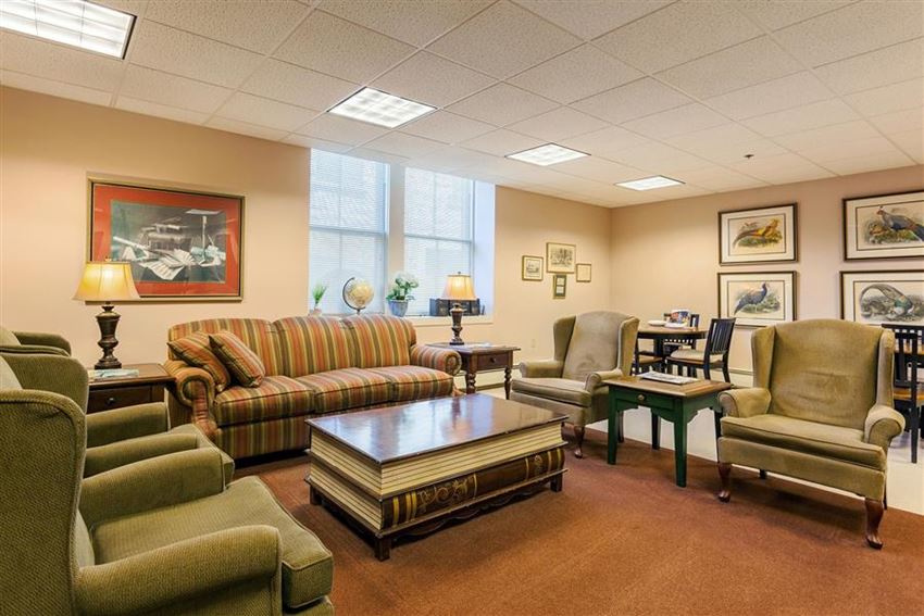 a living room with couches and chairs and a table