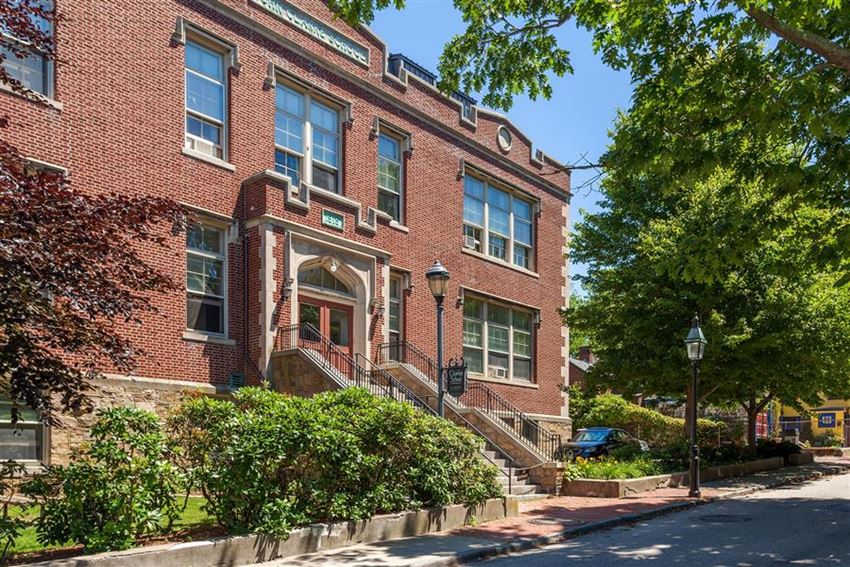 a red brick building with stairs and trees