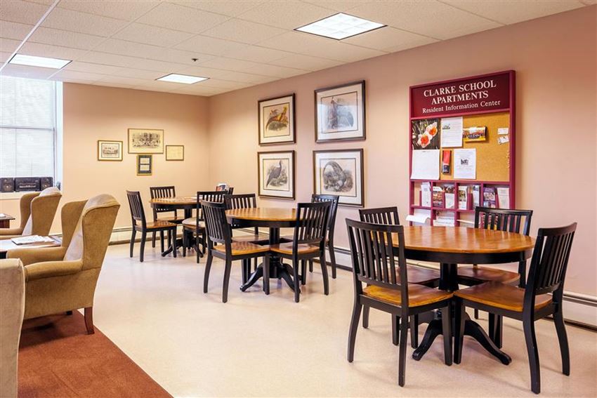 a dining room with tables and chairs and a bulletin board
