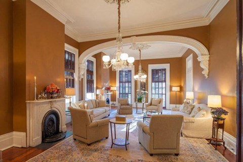 a living room with couches and chairs and a fireplace