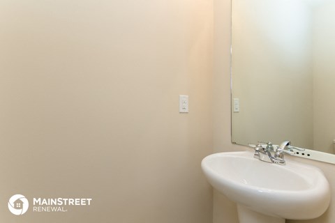 a small bathroom with a sink and a mirror