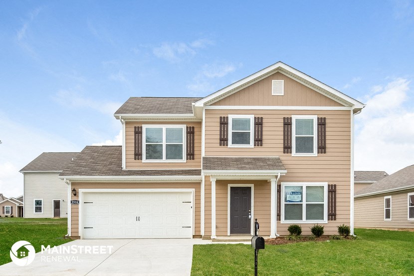 a beige house with a white garage door