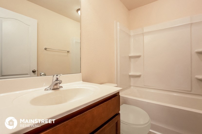 a bathroom with a sink and a toilet and a tub