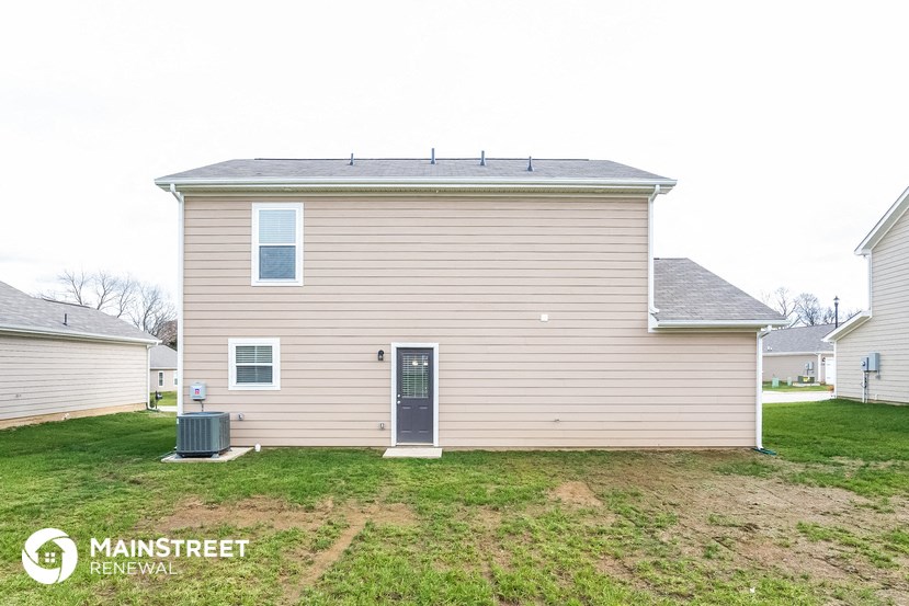 a small house with a yard in front of it