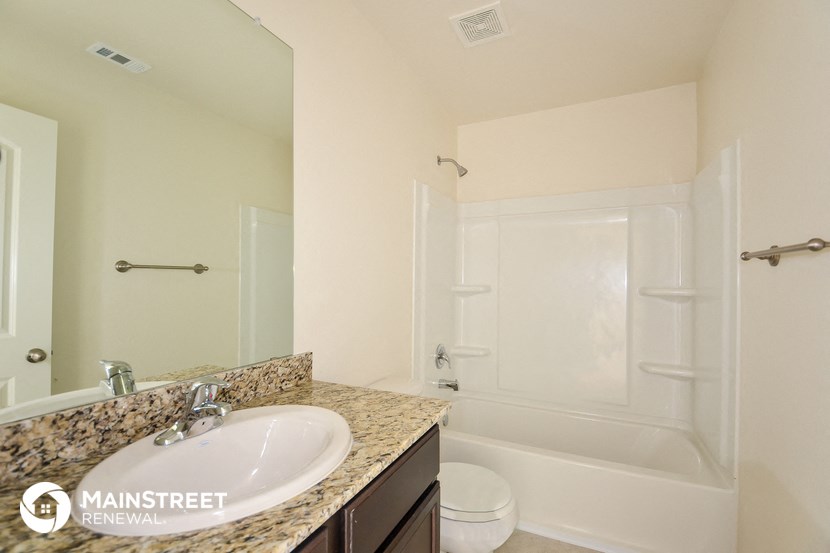 a bathroom with a sink and a shower and a toilet