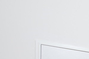 a row of white closets in a room with a wood floor
