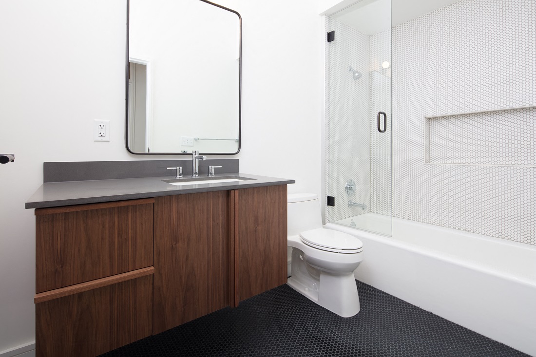 a bathroom with a toilet and a sink and a shower