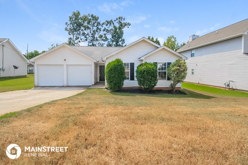 a white house with a yard in front of it