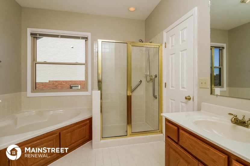 two sinks in a bathroom with a shower and a tub