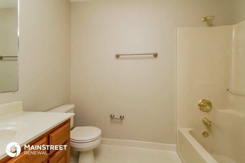 a bathroom with a toilet and a shower and a sink