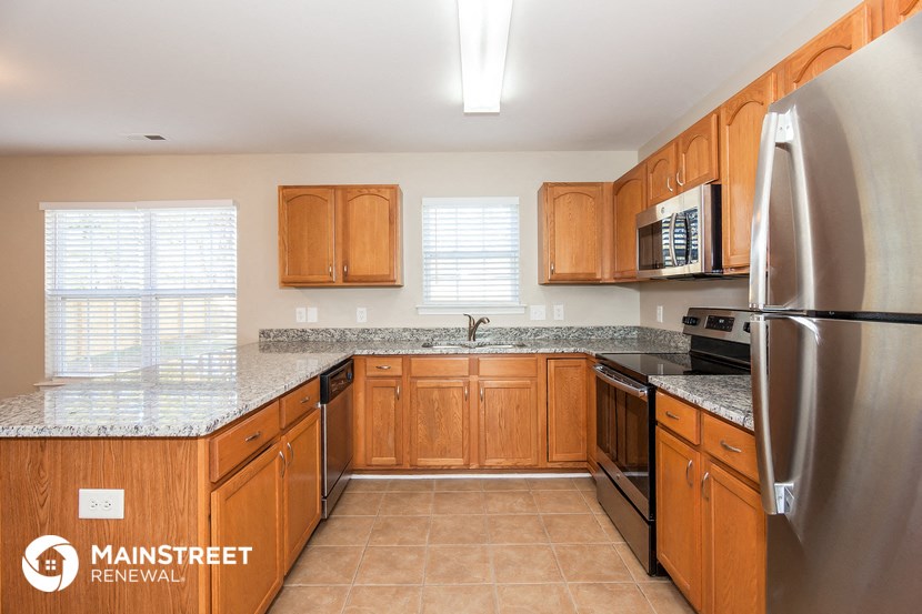 a kitchen with wooden cabinets and stainless steel appliances
