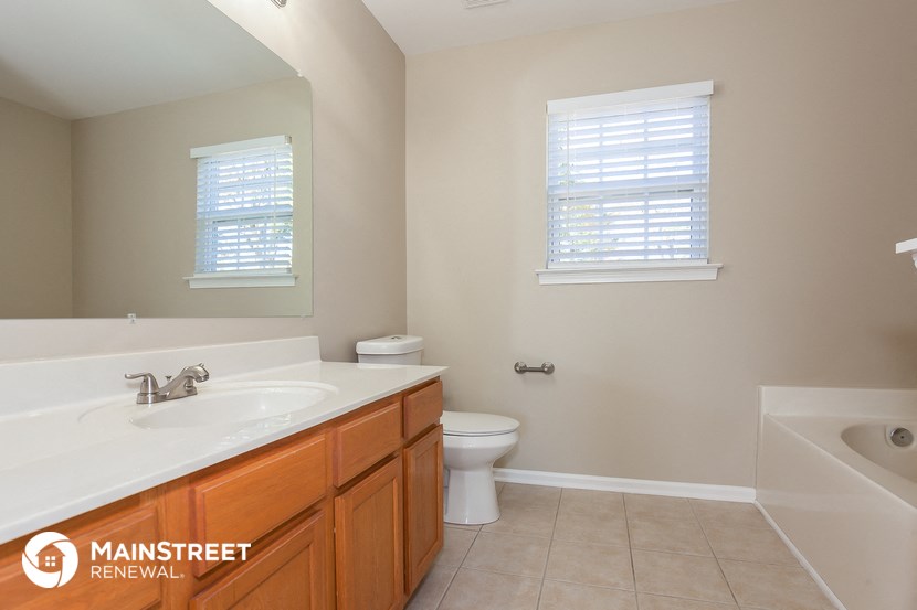 a bathroom with a sink and a toilet and a bath tub