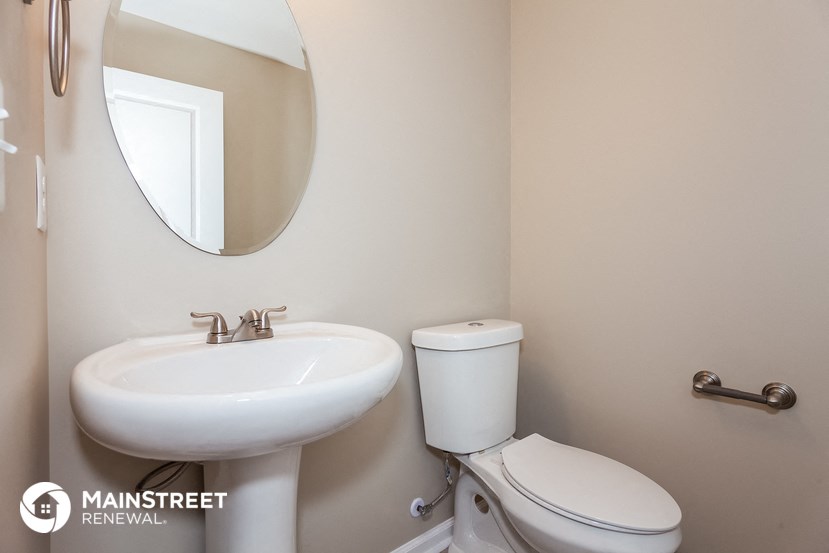a bathroom with a sink and a toilet and a mirror