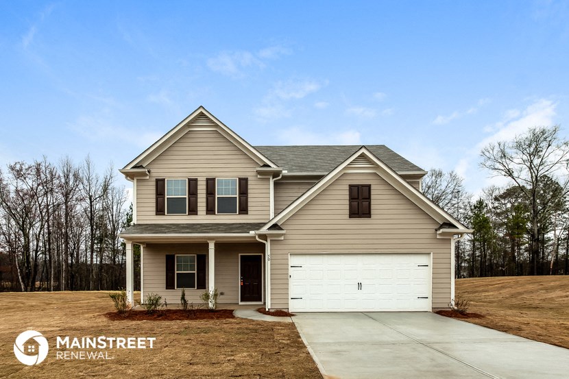 a beige house with a white garage door
