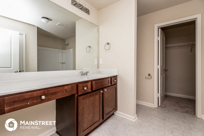 a bathroom with a sink and a mirror and a shower
