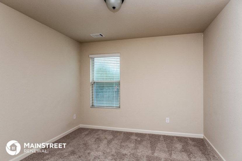 the upstairs bedroom with carpet and window
