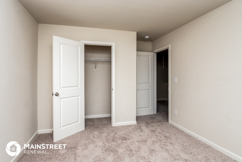 a bedroom with a closet and a door to a closet