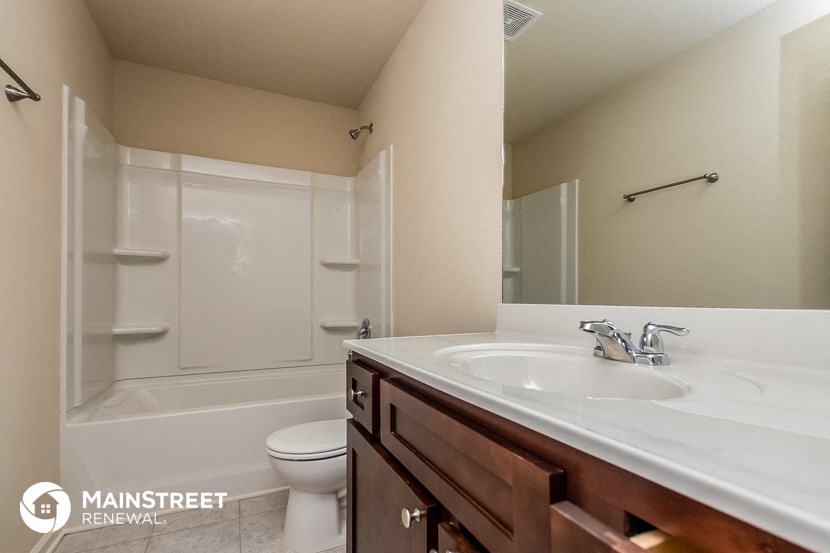 a bathroom with a sink and a toilet and a shower