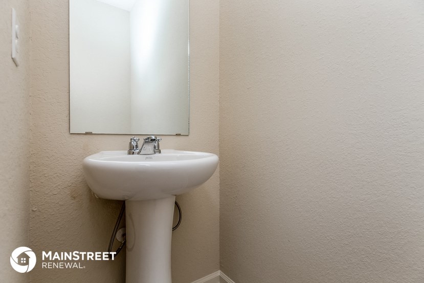 a small bathroom with a sink and a mirror