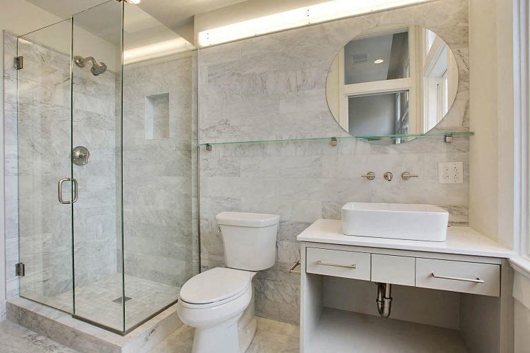 a bathroom with a toilet and a sink and a shower
