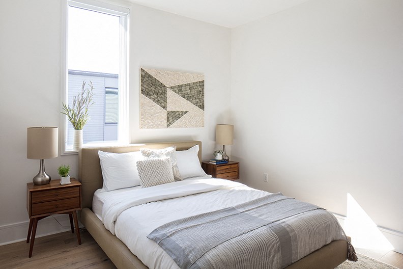 a bedroom with a bed and a window