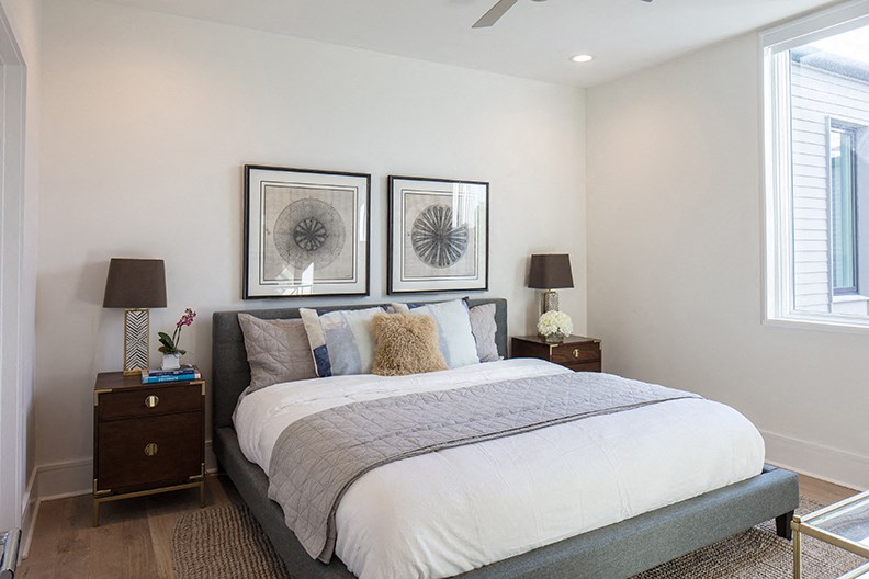 a bedroom with a bed and two pictures on the wall