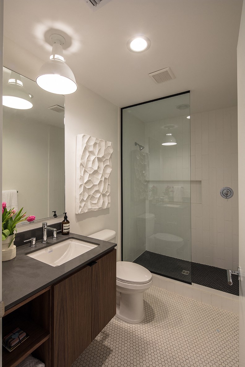 a bathroom with a toilet sink and a shower