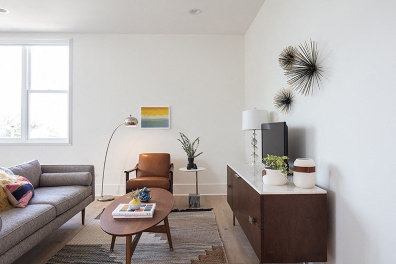 a living room with a couch and a coffee table and a tv