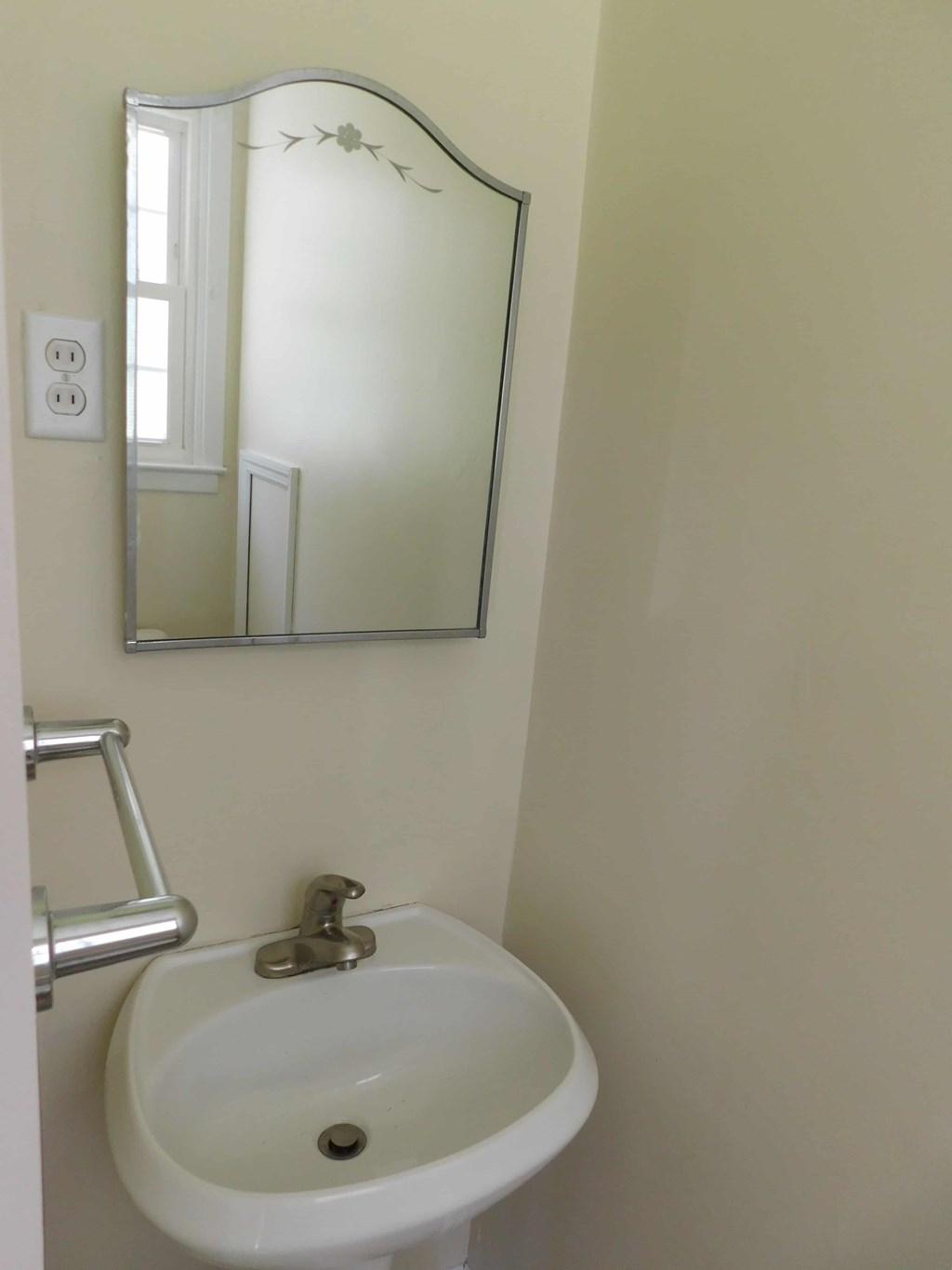 a small bathroom with a sink and a mirror