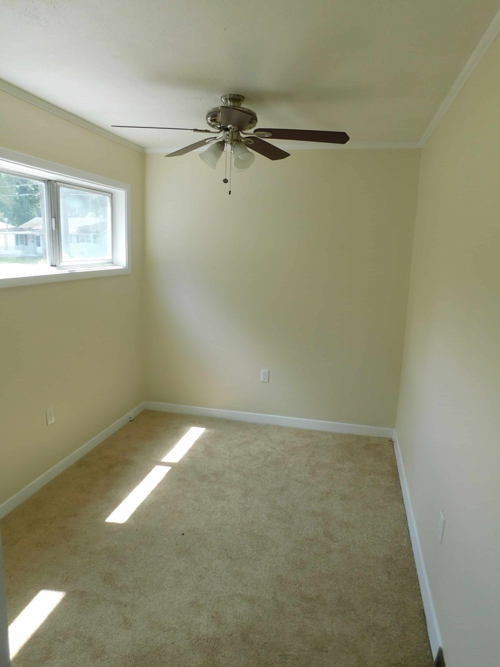 a empty room with a ceiling fan
