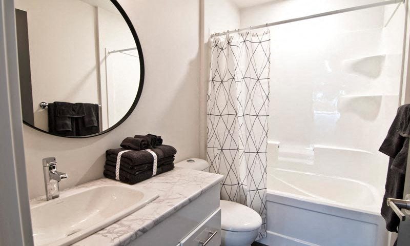 a bathroom with a toilet and a sink and a shower