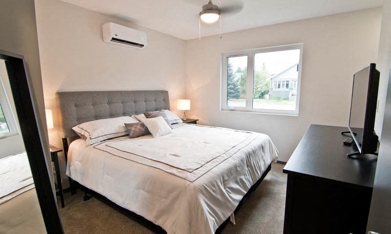 a bedroom with a bed and a tv