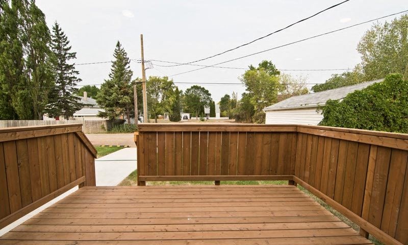 a wooden deck with a bench on top of it