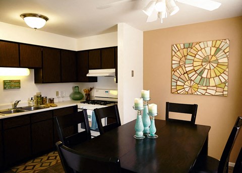a kitchen and dining room with a table and chairs