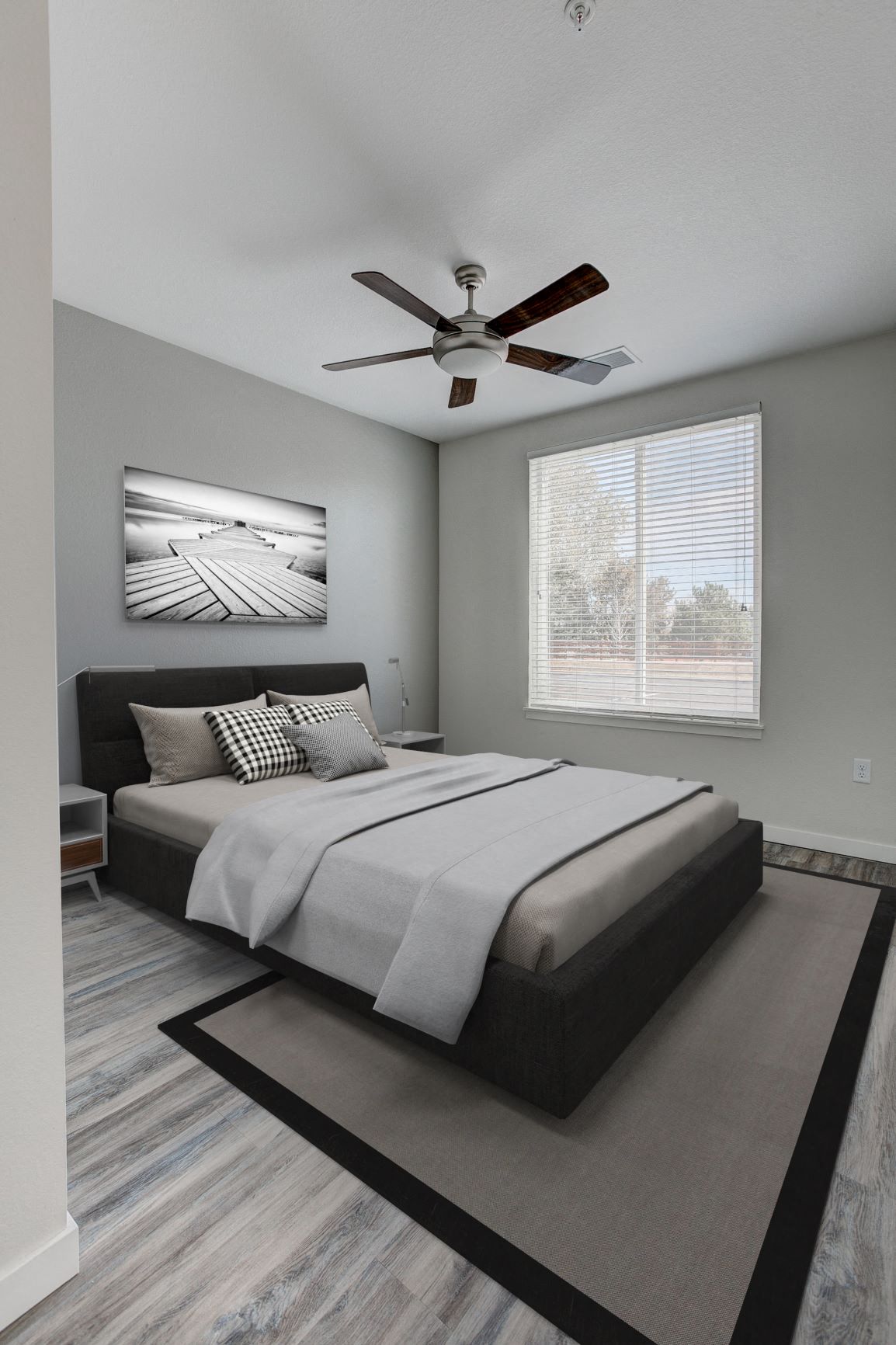a bedroom with a ceiling fan and a bed