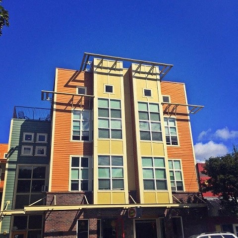 a tall building with a blue sky in the background